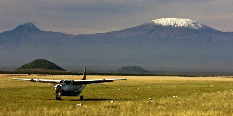 Light aircraft on an airstrip with Mount Kilimanjaro in the background, Amboseli